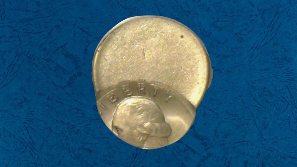 1970-D quarter off-center strike showing design shifted to one side with large blank crescent area and date visible